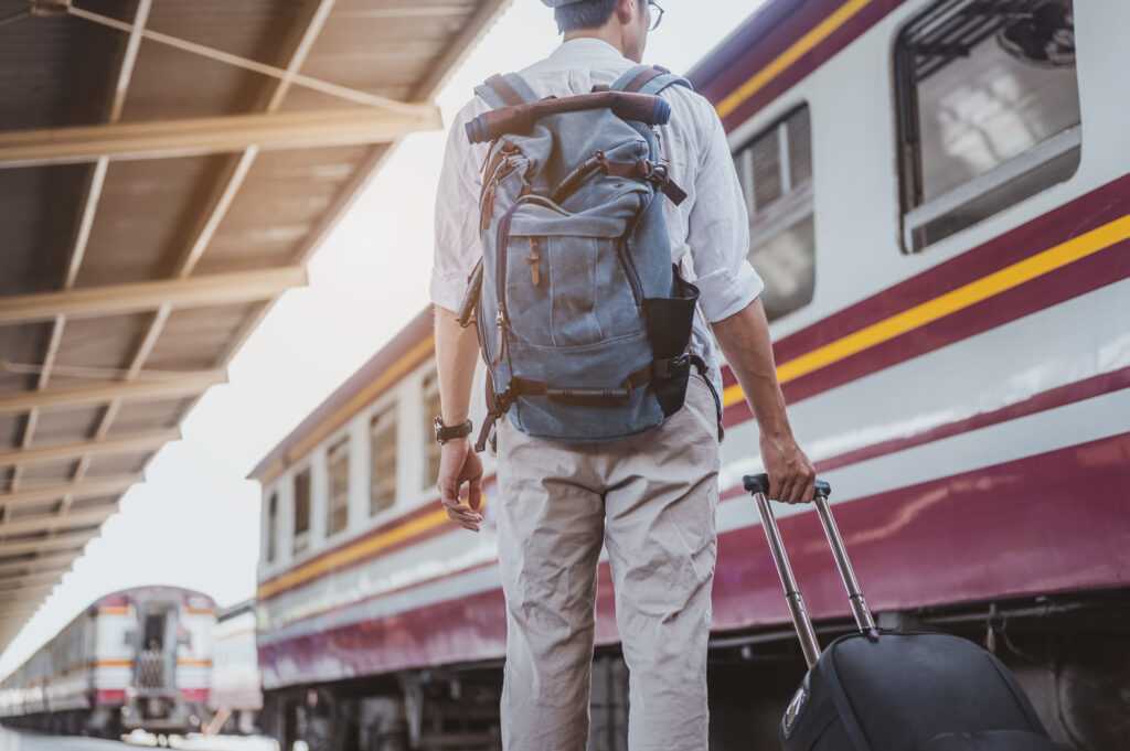 asian-man-carrying-his-luggage-in-the-train-statio-2026-03-17-14-46-41-utc