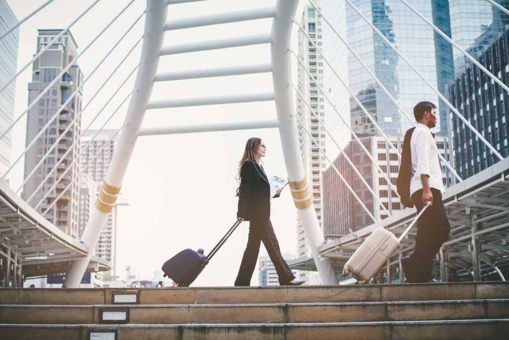 businessman-and-businesswoman-dragging-a-suitcase-2026-03-26-22-50-38-utc