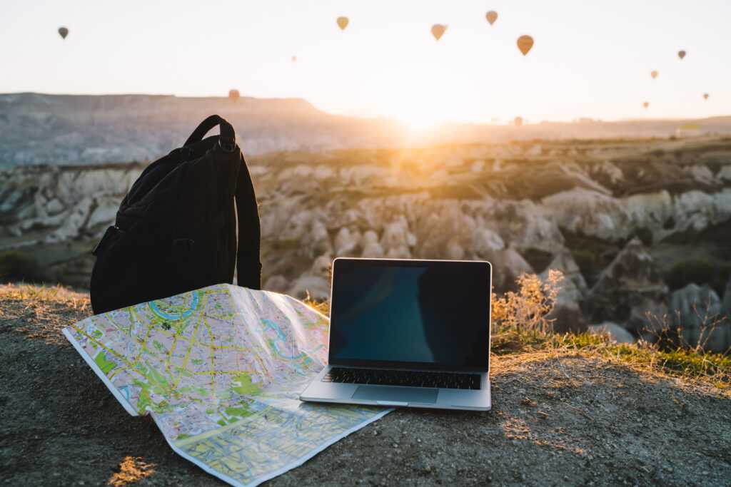 laptop-and-map-on-hill-at-dawn-2026-03-24-22-44-34-utc