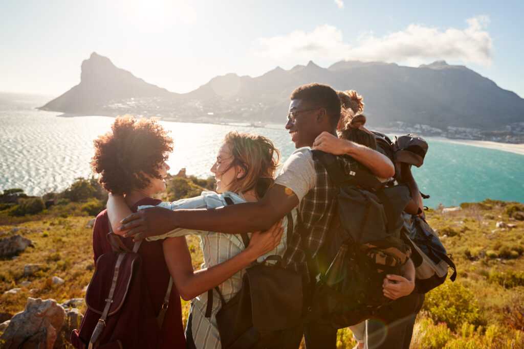 millennial-friends-on-a-hiking-trip-embrace-at-the-2026-03-10-03-17-21-utc