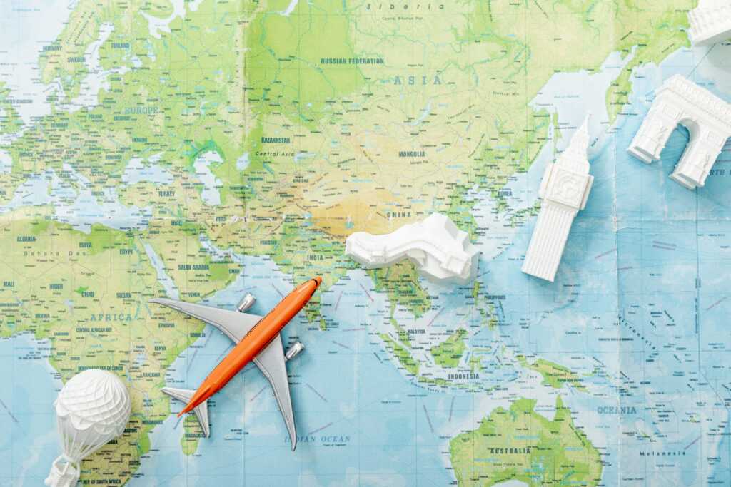 top-view-of-small-plane-on-map-near-world-attracti-2026-03-11-04-18-45-utc